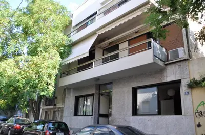 a building with cars parked in front of it at Under the shade of Acropolis by YHA in Athens