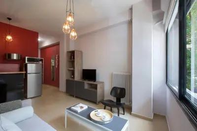a living room with a couch and a table at Under the shade of Acropolis by YHA in Athens