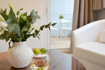 a vase of flowers on a table in a living room at Alekos Apartments 1 - Νetflix & Comfort in Athens