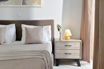 a bedroom with a bed and a night stand with a lamp at Alekos Apartments 1 - Νetflix & Comfort in Athens