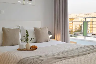 a bedroom with a bed with a vase with a plant on it at Alekos Apartments 1 - Νetflix & Comfort in Athens