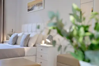a bedroom with a bed with a lamp on a night stand at Alekos Apartments 1 - Νetflix & Comfort in Athens