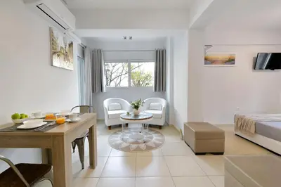 a living room with a bed and a dining room at Alekos Apartments 1 - Νetflix & Comfort in Athens