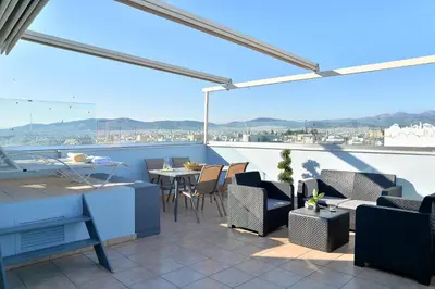 a patio with a table and chairs on a balcony at Alekos Apartments 1 - Νetflix & Comfort in Athens