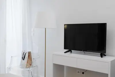a flat screen tv sitting on top of a white entertainment center at Lux Central Apt at Kolonaki Area in Athens