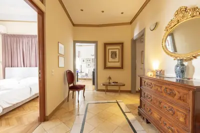 a bedroom with a bed and a mirror and a dresser at Ideal 4 bdr Apartment in Plaka for 10! in Athens