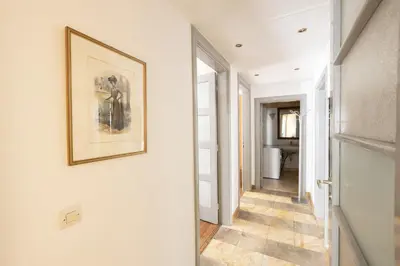 a hallway with a framed picture on the wall and a painting at Ideal 4 bdr Apartment in Plaka for 10! in Athens