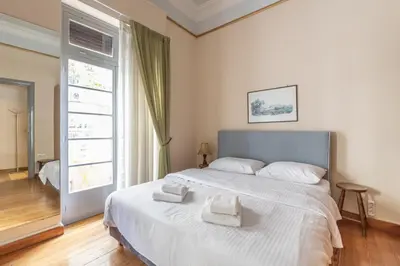 a bedroom with a large bed with two towels on it at Ideal 4 bdr Apartment in Plaka for 10! in Athens
