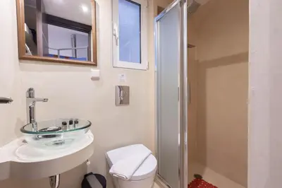 a bathroom with a toilet and a sink and a shower at Ideal 4 bdr Apartment in Plaka for 10! in Athens