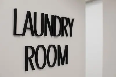 a sign for a room with the words laundry room at Euryclea Residences in Athens