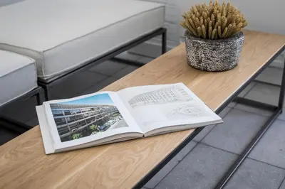 an open book on a table with a plant at Euryclea Residences in Athens