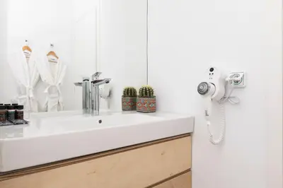 a bathroom with a white sink and a phone at Euryclea Residences in Athens