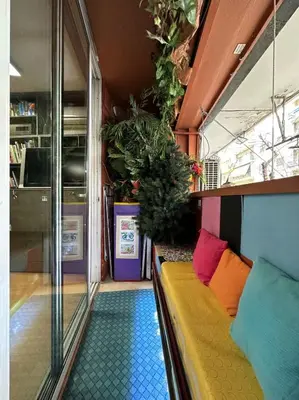 a yellow couch in a room with plants at Athens centre diamond in Athens