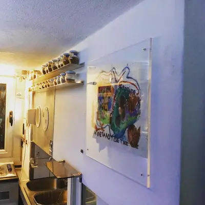 a kitchen with a painting on the wall at Athens centre diamond in Athens