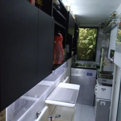a kitchen with black cabinets and a white counter top at Athens centre diamond in Athens