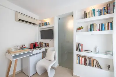 a room with a desk and a chair and books at The Room with a View in Athens