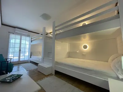 a room with two bunk beds and a table at Sarwnisland in Lagonissi