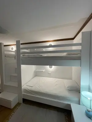 a bedroom with two bunk beds with white sheets at Sarwnisland in Lagonissi