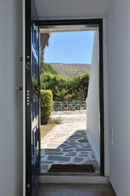 an open door of a house with a view at Sarwnisland in Lagonissi