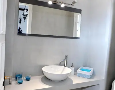 a bathroom with a white sink and a mirror at Sarwnisland in Lagonissi