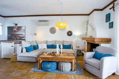 a living room with a couch and a table at Sarwnisland in Lagonissi