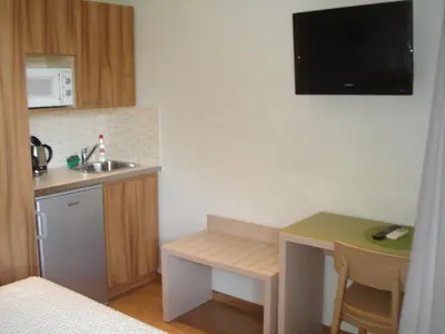 a small kitchen with a sink and a small table at Elements Rooms & Apartments in Athens