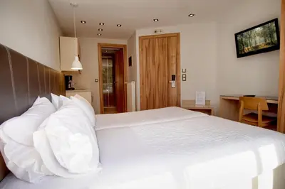 a bedroom with a large white bed with white pillows at Elements Rooms & Apartments in Athens