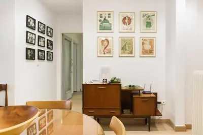 a dining room with a table and some pictures on the wall at Athens Vintage Apartment - Pagrati in Athens
