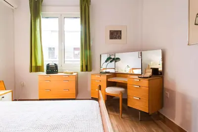 a bedroom with a desk and a bed and a mirror at Athens Vintage Apartment - Pagrati in Athens