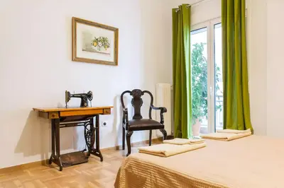a bedroom with a desk and a chair next to a bed at Athens Vintage Apartment - Pagrati in Athens
