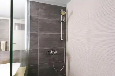 a bathroom with a shower with a toilet and a sink at Athens Vintage Apartment - Pagrati in Athens