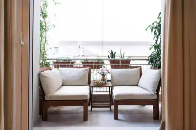 a table with two chairs and a table with pillows at Athens Vintage Apartment - Pagrati in Athens