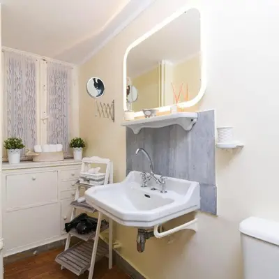 a bathroom with a sink and a mirror at Classy Apartment in the Heart of Athens in Athens