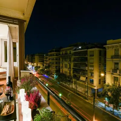 a view of a city at night from a balcony at Classy Apartment in the Heart of Athens in Athens