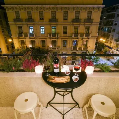 a table with two chairs and two glasses of wine at Classy Apartment in the Heart of Athens in Athens