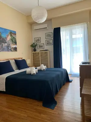 a bedroom with a large bed with two towels on it at Renovated cozy apartment near to Acropolis in Athens