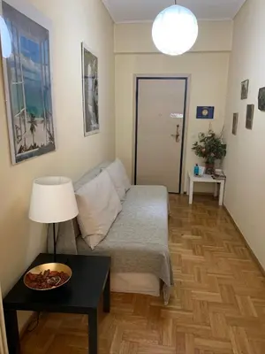 a living room with a bed and a table at Renovated cozy apartment near to Acropolis in Athens