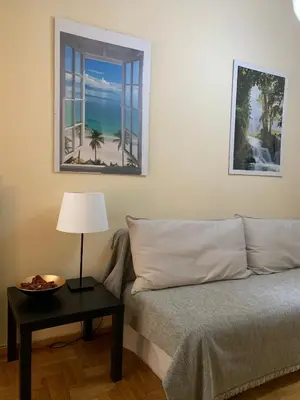 a bedroom with a bed and a table with a lamp at Renovated cozy apartment near to Acropolis in Athens