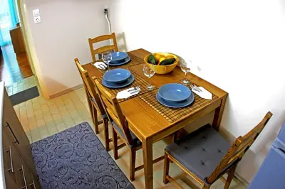 a dining room table with blue plates and a bowl of fruit at Renovated cozy apartment near to Acropolis in Athens