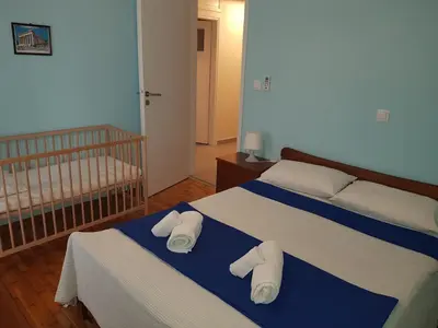 a bedroom with two beds with towels on them at Koukaki Apt 5 min walk to Acropolis in Athens