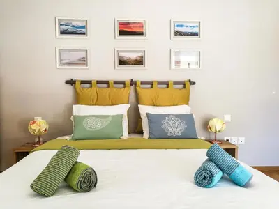 a bedroom with a bed with two pillows on it at The Grove House in Athens
