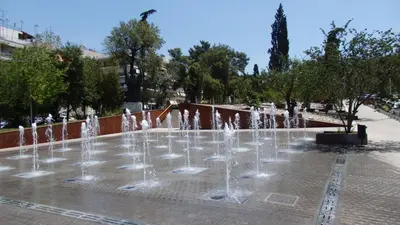 a group of water fountains in a park at The Grove House in Athens