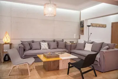 a living room with a couch and a table at The Grove House in Athens