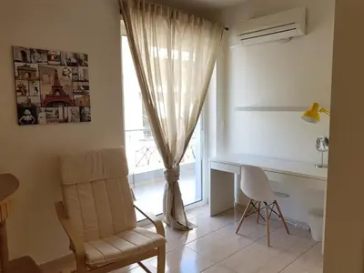 a room with a desk and a chair and a window at Errathens Zephyr Apartment - Athens Center, 3 BD, 1 BATH in Athens