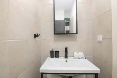 a bathroom with a white sink and a mirror at Athens Connection Apartments in Athens