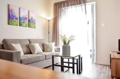 a living room with a couch and a table at Athens Connection Apartments in Athens