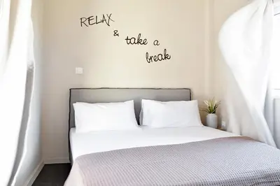 a bedroom with a bed with the words relax and take a ride at Athens Connection Apartments in Athens