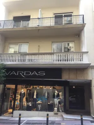 a store front of a building with a balcony at Voula's Apartment in Athens