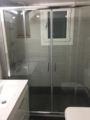 a bathroom with a shower and a toilet and a sink at Voula's Apartment in Athens