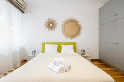 a bedroom with a bed with towels on it at Apartments Historical Center in Athens